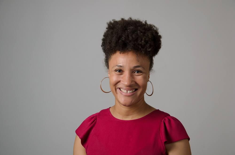 Portrait of Karima Jackson wearing a red blouse.