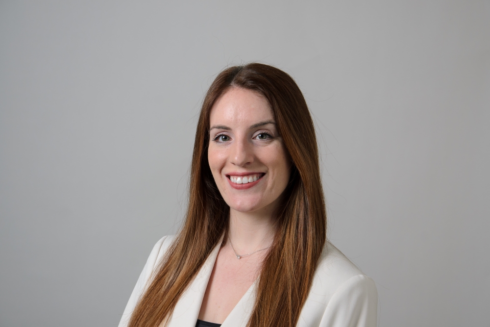 Portrait of Aviana Rosen wearing a white blazer.